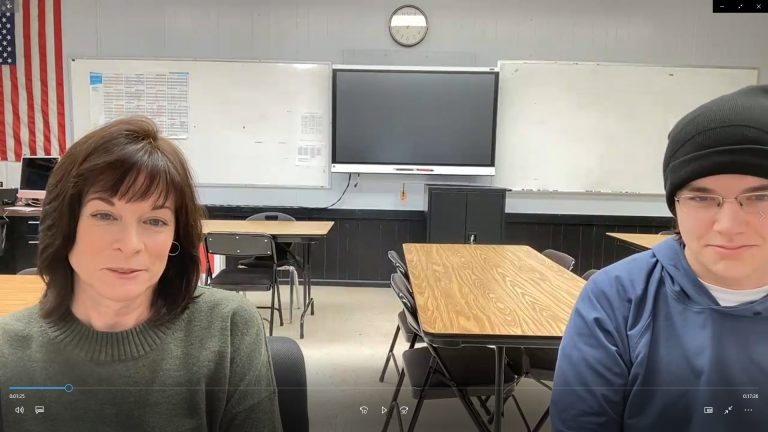 photo of two people in a classroom, Zoom photo.