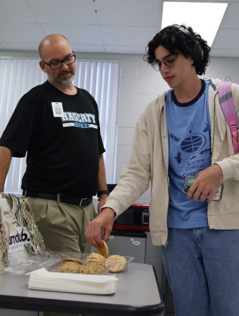 Brit Taylor with a yearbook student in the classroom setting